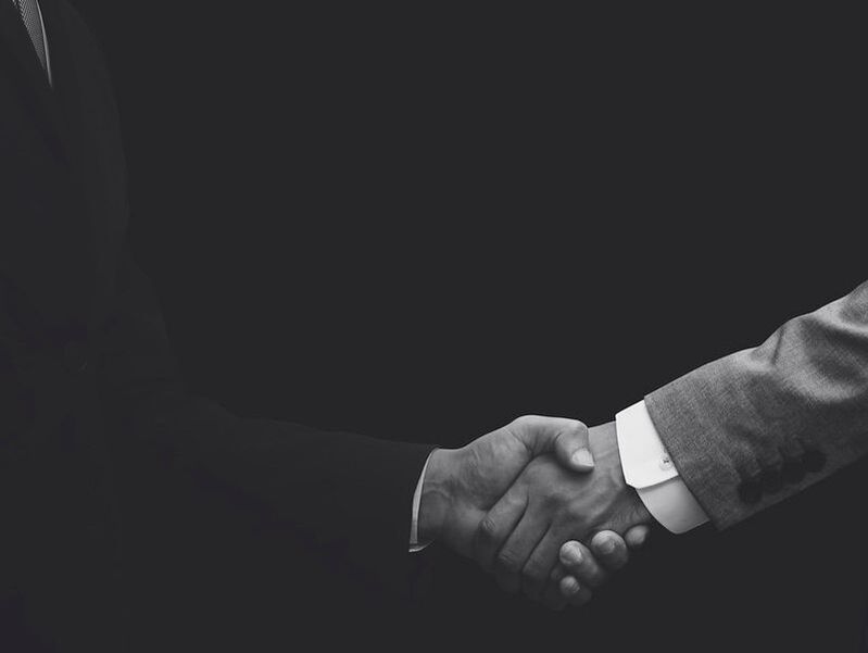 Handshake between business staff member and a client